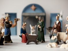 figurines of people and animals in front of a nativity scene