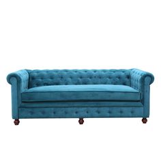 a blue couch sitting on top of a white floor