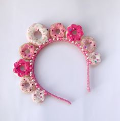 a headband made out of donuts with pink and white sprinkles