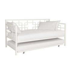 a white daybed with two pillows on it and a pillow case underneath the bed