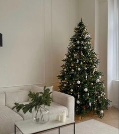 a living room with a christmas tree in the corner