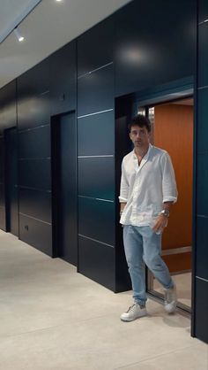 a man standing in an elevator with his hands in his pockets