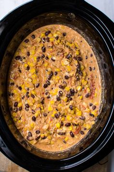 a crock pot filled with black beans and corn