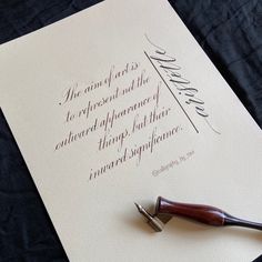 a fountain pen sitting on top of a piece of paper