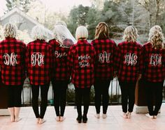 the bridesmaids are wearing red and black flannel shirts with monogrammed letters