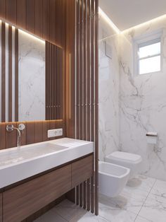 a bathroom with white marble and wood accents