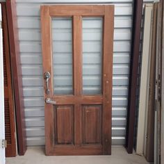 a wooden door sitting inside of a building