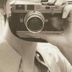 a man taking a photo with an old camera