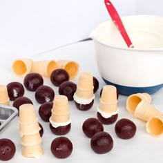 grapes and marshmallows cut up on a counter with a bowl of yogurt in the background