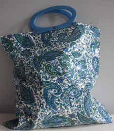 "Rare PVC tote shopper bag with beautiful paisley print and umbrella holder. There was a fastening inside, but this is missing it's popper. Please see photos. This is reflected in the price. MEASUREMENTS IN INCHES  WIDTH: 14.5\" HEIGHT: 15.5\" HANDLE LENGTH: 11\" Any questions, please don't hesitate to ask!" Vintage Blue Tote Shoulder Bag, Retro Blue Handmade Bags, Retro Handmade Blue Bags, Handmade Vintage Blue Shoulder Bag, Umbrella Holder, Shopper Bag, Paisley Print, Umbrella, 1960s