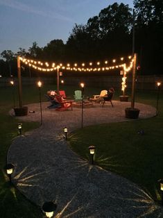 an outdoor patio with string lights and lawn chairs