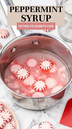 red and white peppermint syrup in a pot with candy canes on the side