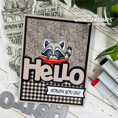 a card with a raccoon on it that says hello, and is surrounded by other cards