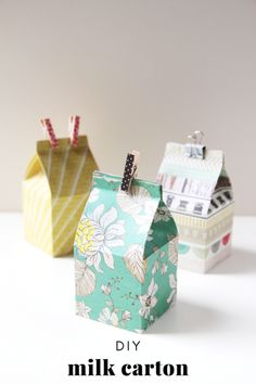 three small boxes with clothes pins in them and the words diy milk carton gift boxes