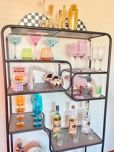 a metal shelf filled with glasses and bottles