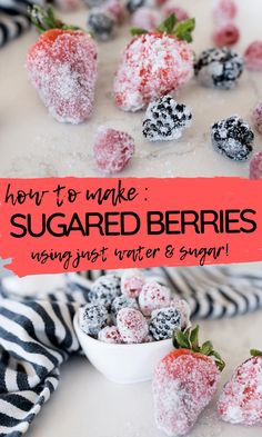 some sugared berries are in a bowl and on top of a table with black and white striped napkins