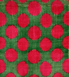 an old red and green cloth with circles on it