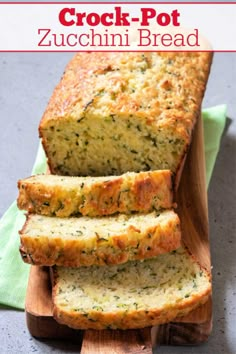 sliced zucchini bread sitting on top of a wooden cutting board