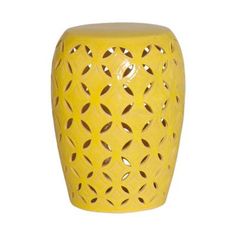 a yellow ceramic stool with holes in the middle and an openwork design on it