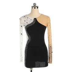 a dress on a mannequin with sequins and sheer - cut sleeves