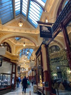 the inside of a building with people walking around