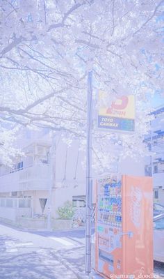 an orange vending machine sitting on the side of a road next to a tree