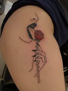 a woman with a rose tattoo on her thigh