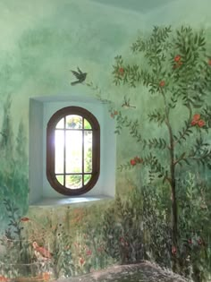 a window in a painted wall with trees and flowers on the outside, and a bird flying over it