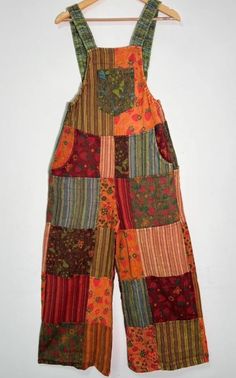 a multicolored patchwork jumpsuit hanging on a hanger