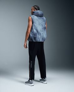 Designed with LOEWE, this quilted puffer vest with tie-dye inspired print adjusts for the perfect fit. Keeps your core cozy | On Men's Puffer Vest LOEWE in Blue/Multicolor, Size: XS. Special edition, all-day wear, LOEWE × On Active Life. Performance All Day | Recycled Polyamide/Polyamide