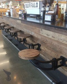 several wooden benches are lined up at the bar