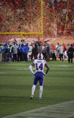 a football player standing on top of a field