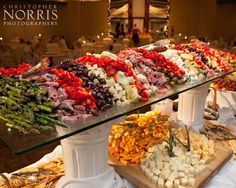 an assortment of different types of food on display in a buffet area at a wedding