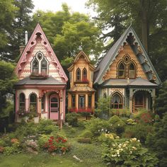 three small houses are in the middle of some bushes and trees, with flowers growing around them