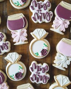 decorated cookies are arranged on a wooden table