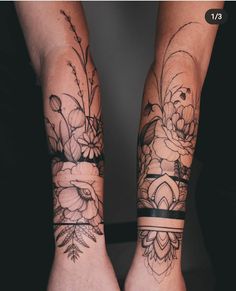 two people with tattoos on their arms and legs, both holding each other's hands