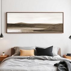 a bed sitting under a painting on the wall