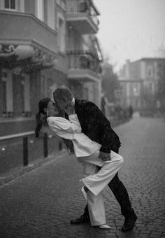 a man and woman kissing in the rain