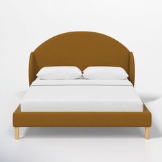 a bed with two pillows on top of it and a headboard made out of wood