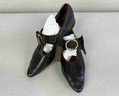 "Match your little on history bounding day when you get them these Edwardian Mary Janes! These black leather shoes feature a fabulous silver rope buckle with silk bow hiding the button strap. They have a pointy toe and barely-there heel. Leather soles. These shoes are in fair vintage condition with wear to the leather and shattering bows but strong soles. Please see measurements for sizing accuracy: Insole Length: 8.25\" Outer Width: 2.5\" Heel Height: .25\" Find our other vintage splendid shoes Buttons And Bows, History Bounding, Miss Mary, Womens Mary Janes, Silk Bow, Leather Flat Shoes, Black Leather Shoes, Gorgeous Shoes, Little Miss