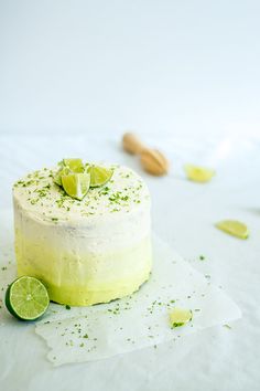 a cake with limes on the top is sitting on paper