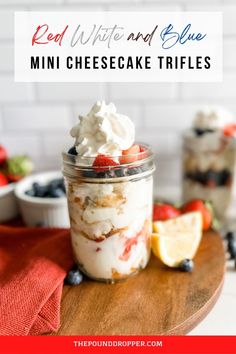 red, white and blue cheesecake trifles in a jar on a wooden board