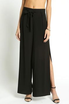 Show off your 'graceful lines' in these stunning wide leg pants this season. The black pants feature a sexy side slit to show off your lower legs and some open toed high heels. The fitted waist has a self tying belt. Available in black 100% rayon Imported Black Capri Pants, Cropped Trousers, Dress C, Fashion Street, Pants Outfit, Black Media, Leg Pants, Wide Leg Pants, Black Pants