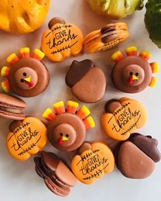 cookies decorated to look like turkeys, macaroons and pumpkins with writing on them