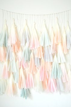 multicolored tissue tassels hanging on the wall