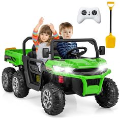 two children riding in a green toy truck with remote control and steering wheel, on white background