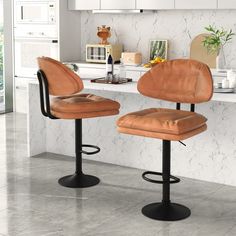 two brown leather stools sitting on top of a kitchen counter next to an oven