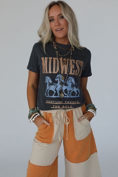 No boho closet is complete without the perfect graphic tee, and the Midwest Fortune Graphic Tee is it! So cool, you won’t want to miss out! Comfortable, mineral-washed, Cotton tee shirt fabric Relaxed and slouchy silhouette for ultimate comfort Classic crew neckline with dropped shoulders and loose short sleeves So cool Western Inspired Running Wild Horses with "MIDWEST - Fortune Favors the Bold" print Pair with: Eye Of The Sun Padded Bralette, The Signature Flare and Shoreline Platform Sandals. Spring Crew Neck Stonewashed T-shirt, Casual Distressed T-shirt For Festivals, Bohemian Style T-shirt For Fall Festival, Bohemian Fall Festival T-shirt, Bohemian Short Sleeve T-shirt For Fall, Fall Festival Graphic Print T-shirt, Vintage Washed T-shirt For Festival, Stonewashed Cotton Graphic Tee, Bohemian Crew Neck T-shirt For Fall