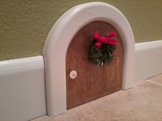 a door with a wreath on it and a red bow