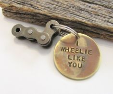 a close up of a key chain with a tag on it that says, wheelie like you